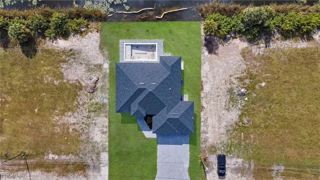 an aerial view of a house with a yard