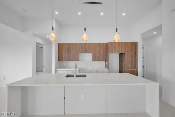 a view of kitchen with a sink and chandelier