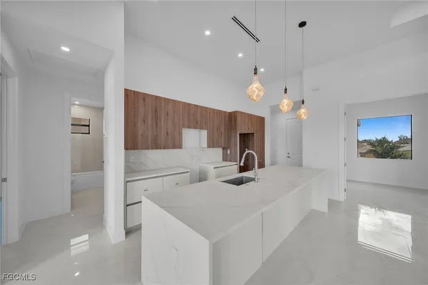 a kitchen with a sink a counter top space stainless steel appliances and a window