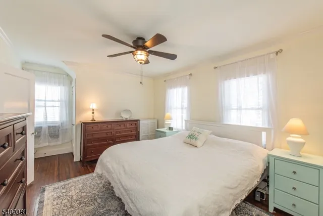 a bedroom with a bed a chandelier and a window