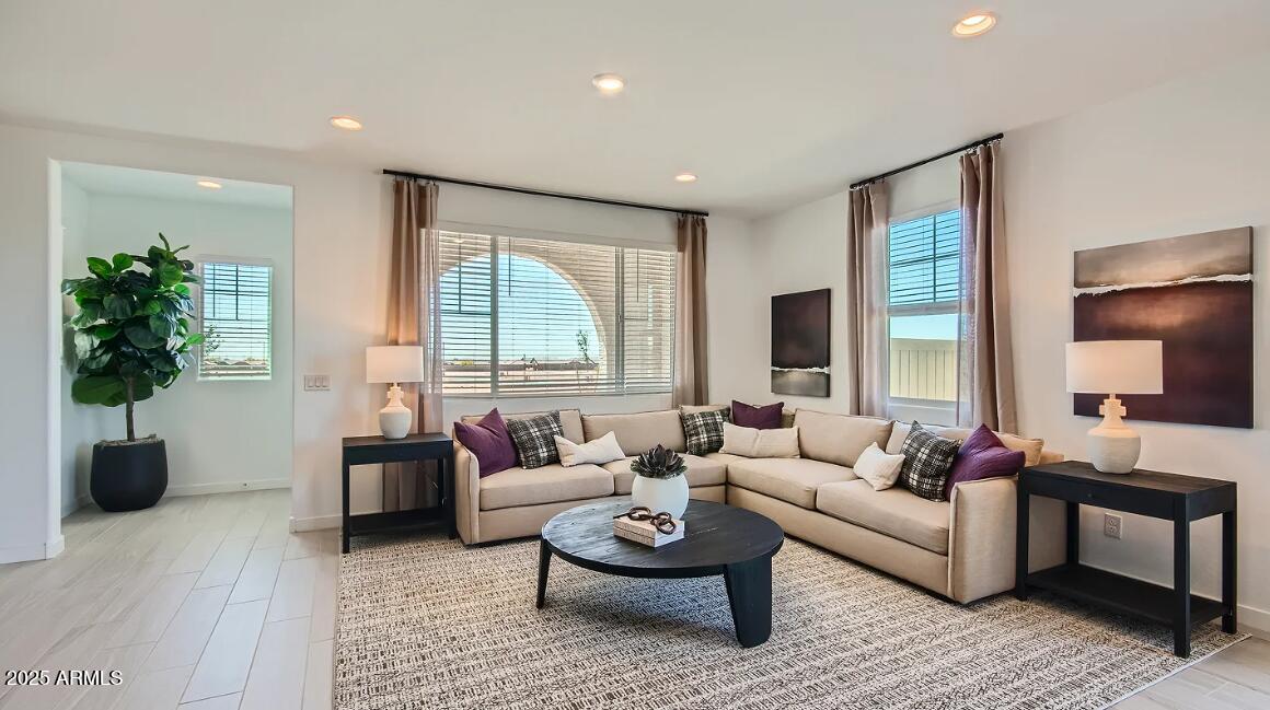 16433 West Weeping Willow Road Surprise, AZ 85387 - Photo 9 of 22 a living room with furniture potted plant and a large window
