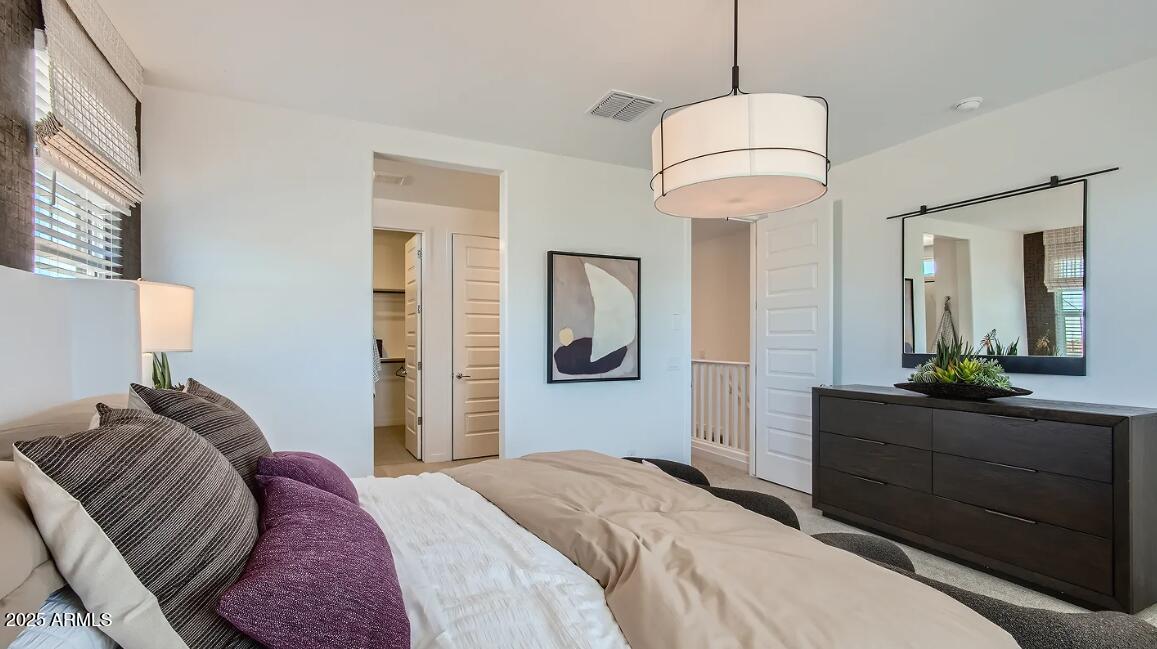 16433 West Weeping Willow Road Surprise, AZ 85387 - Photo 12 of 22 a bedroom with a bed and a mirror