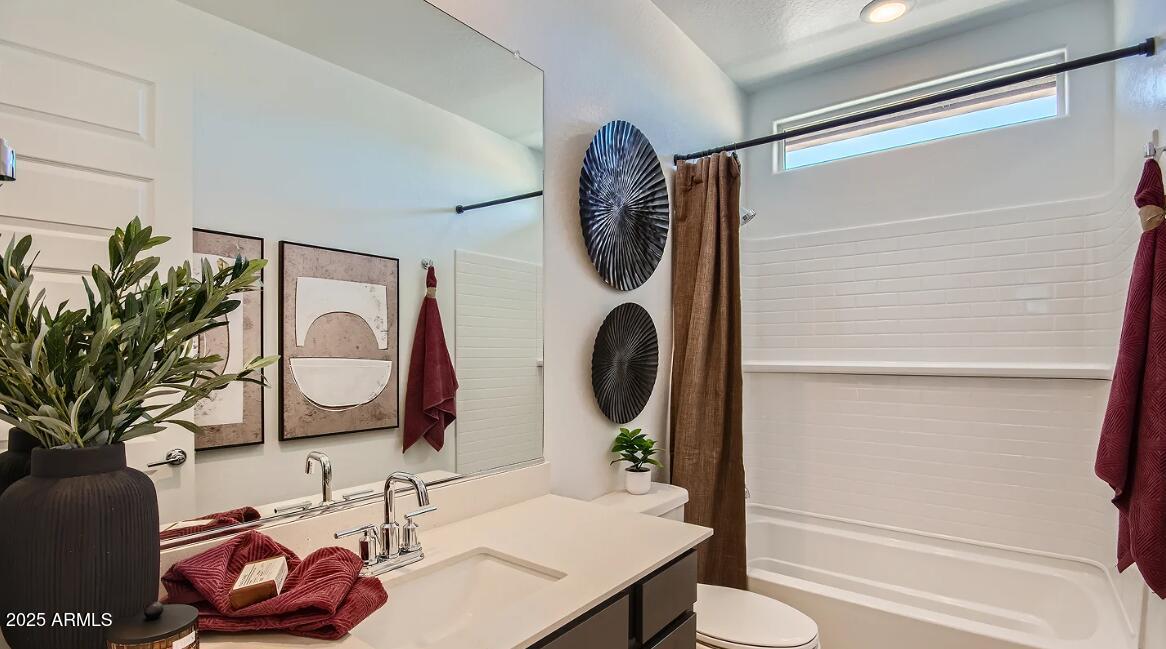 16433 West Weeping Willow Road Surprise, AZ 85387 - Photo 18 of 22 a bathroom with a sink and a mirror