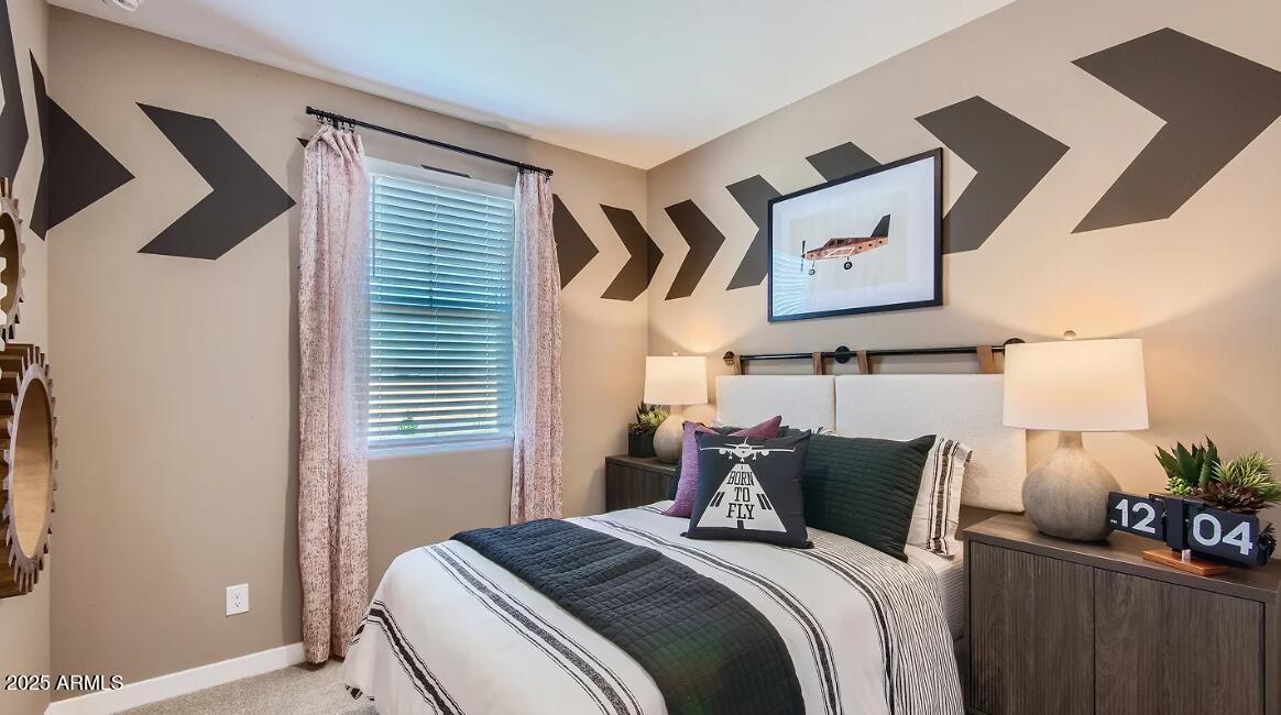 16433 West Weeping Willow Road Surprise, AZ 85387 - Photo 19 of 22 a bed sitting in a bedroom next to a window