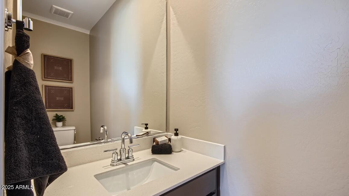16433 West Weeping Willow Road Surprise, AZ 85387 - Photo 20 of 22 a bathroom with a sink and a mirror