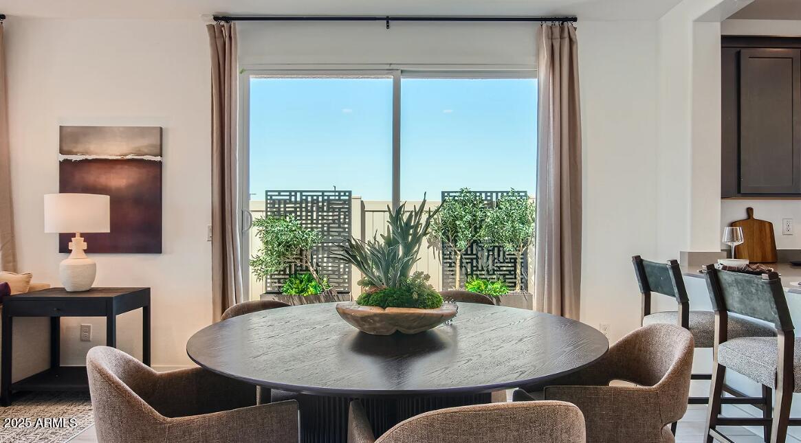 16433 West Weeping Willow Road Surprise, AZ 85387 - Photo 7 of 22 a view of a dining room with furniture window and wooden floor
