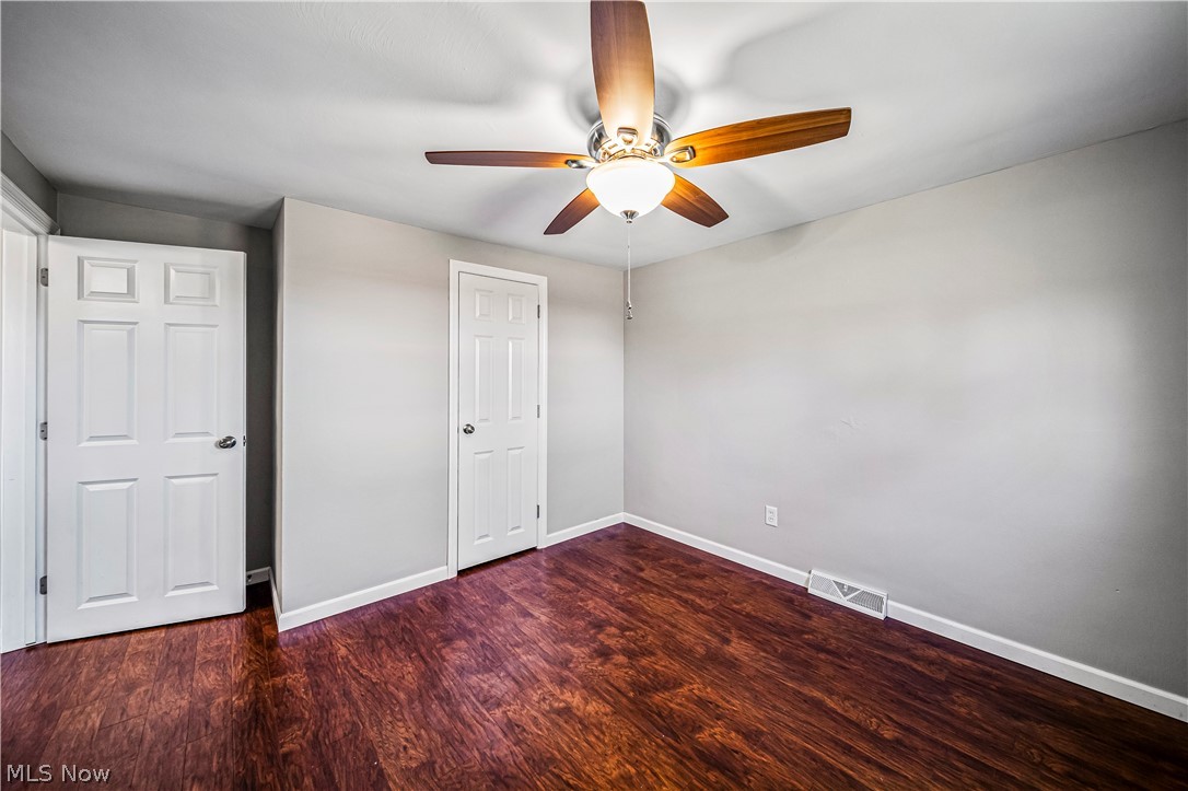 3395 Maple Road Jefferson, OH 44047 - Photo 24 of 36 Unfurnished bedroom with ceiling fan and dark hardwood / wood-style floors