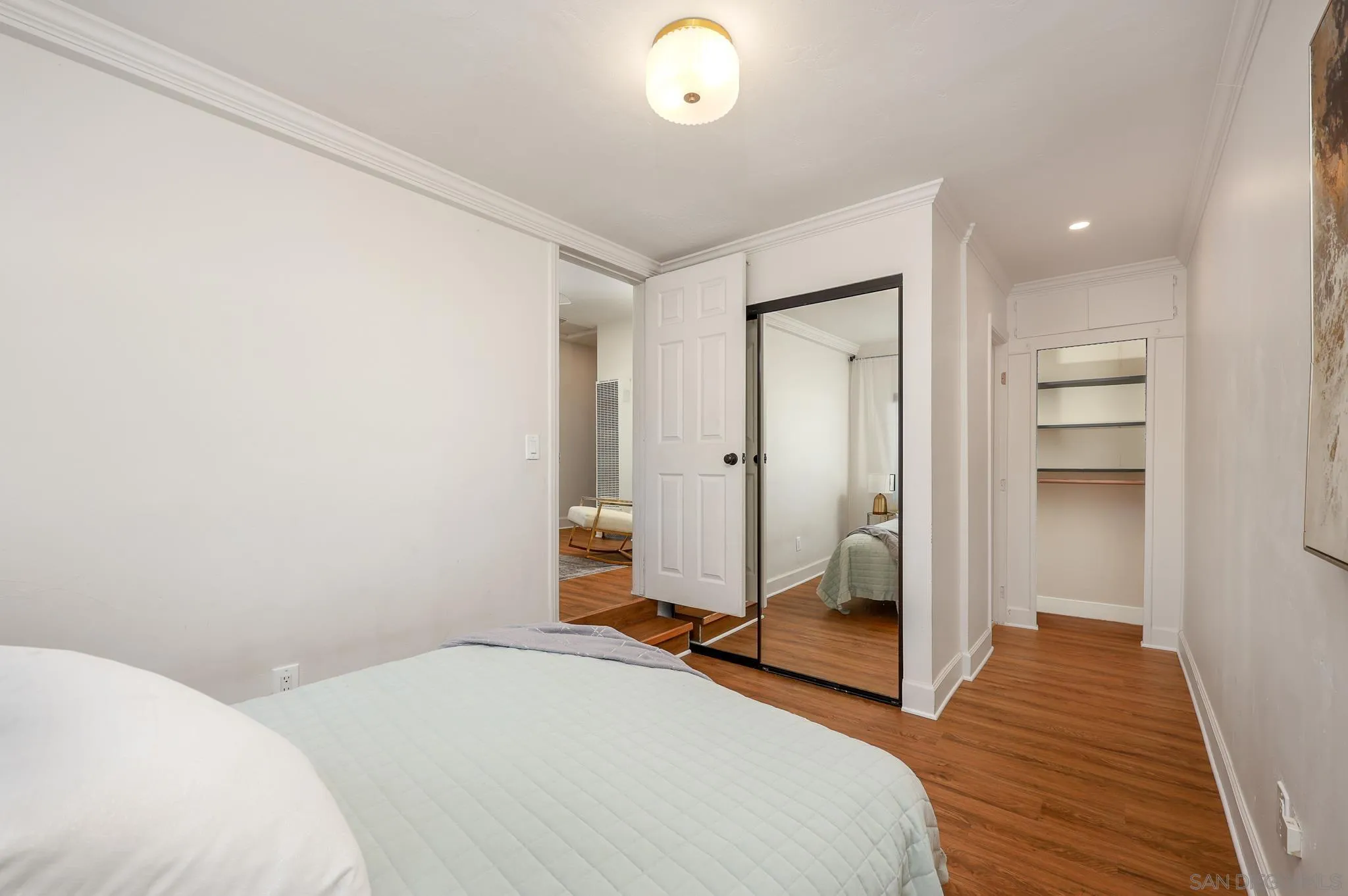 2146 El Pasillo Lane Spring Valley, CA 91977 - Photo 13 of 30 a bedroom with a bed and a chandelier