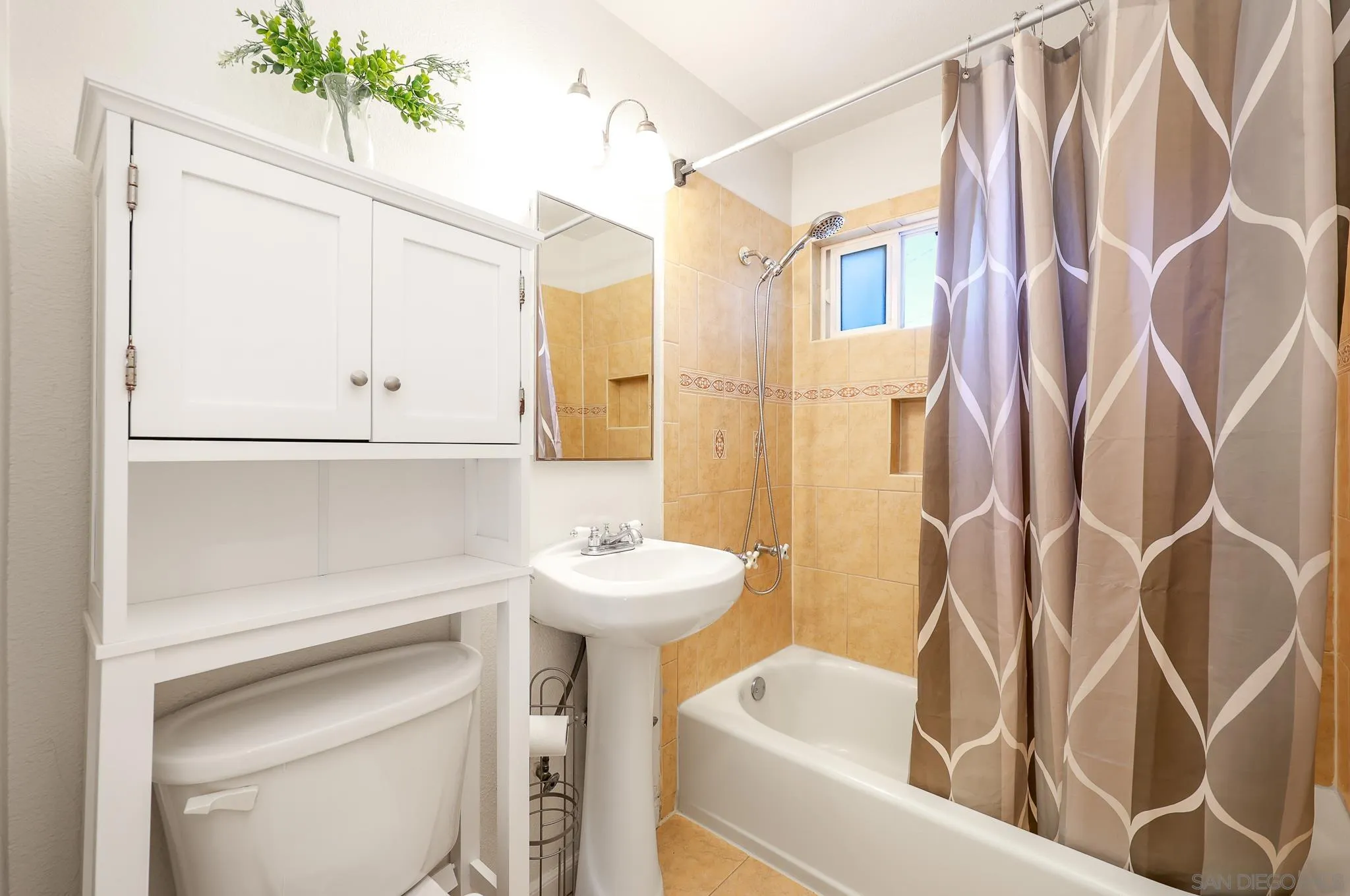 2146 El Pasillo Lane Spring Valley, CA 91977 - Photo 17 of 30 a bathroom with a sink a toilet and shower