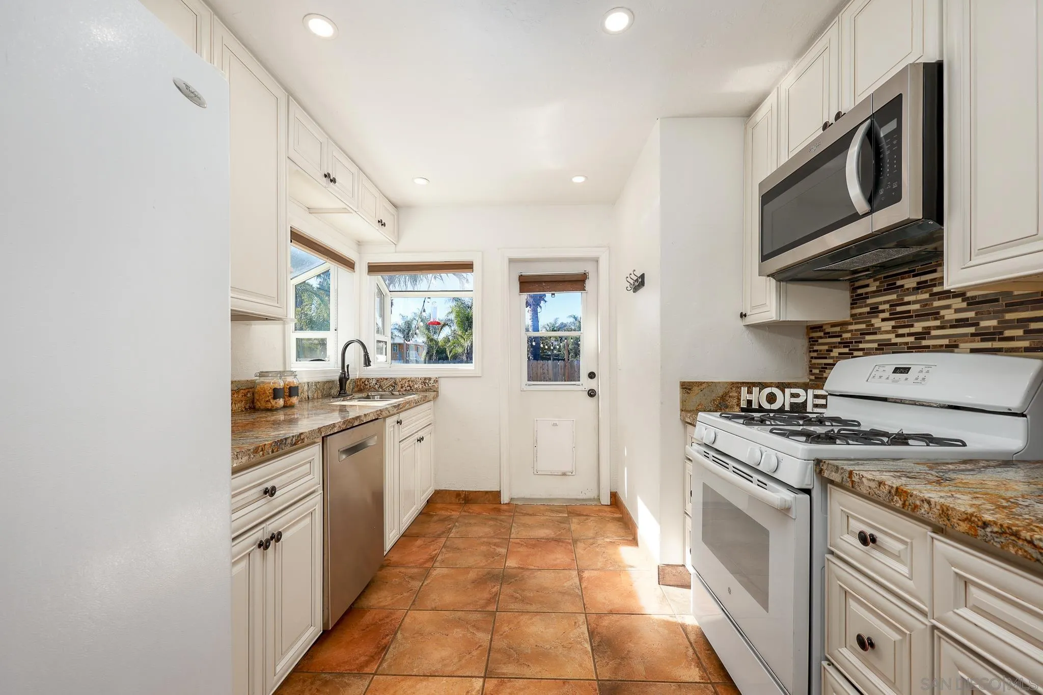 2146 El Pasillo Lane Spring Valley, CA 91977 - Photo 9 of 30 a kitchen with stainless steel appliances granite countertop a stove and a sink