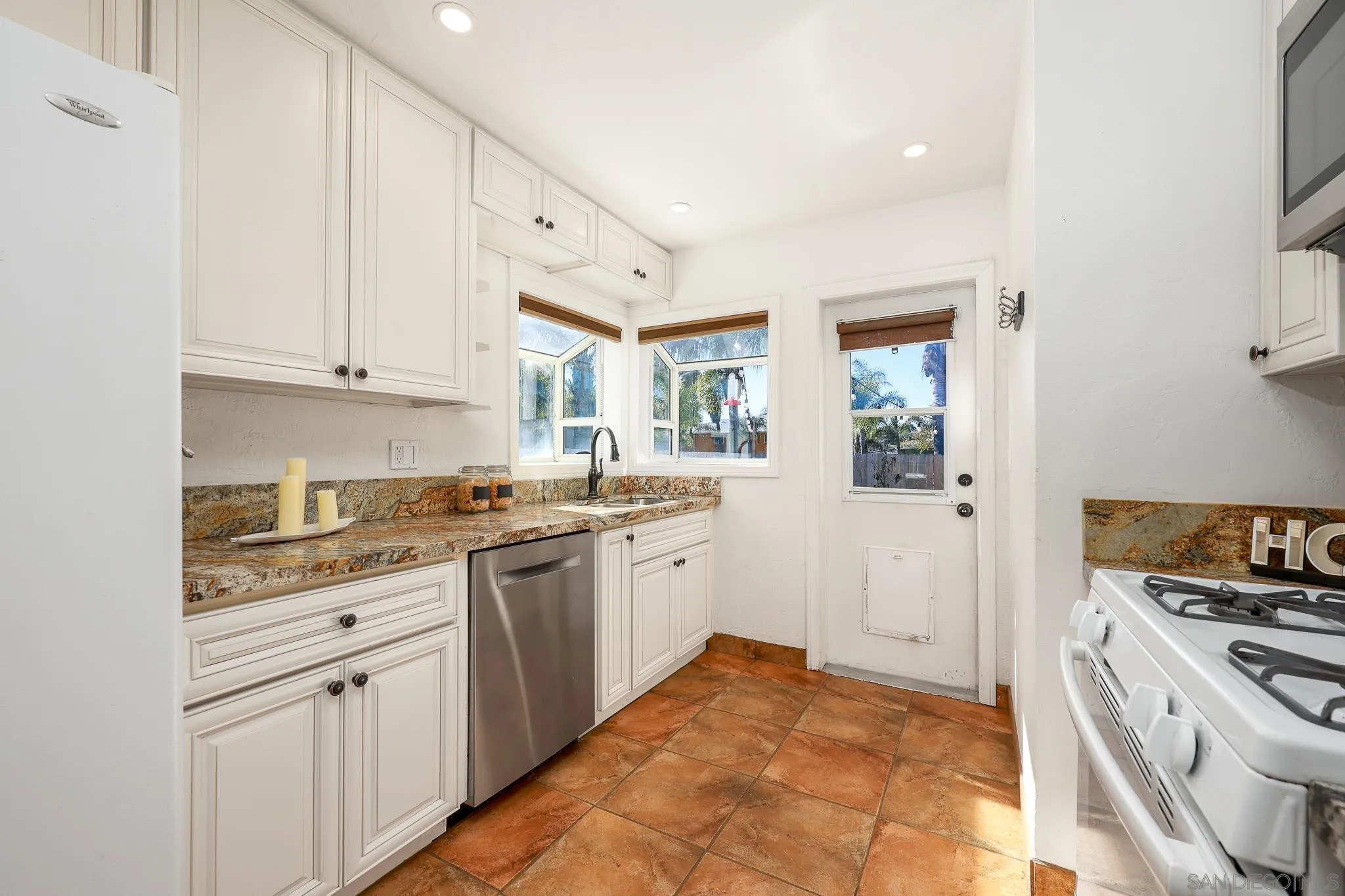 2146 El Pasillo Lane Spring Valley, CA 91977 - Photo 10 of 30 a kitchen with granite countertop white cabinets and white appliances