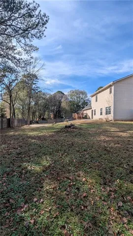 a view of a outdoor space with deck and tree