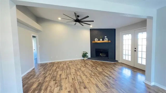 a view of a livingroom with a fireplace and wooden floor
