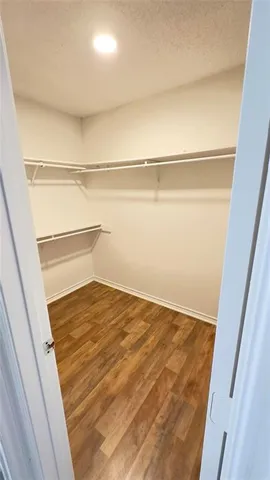 a view of a room with wooden floor