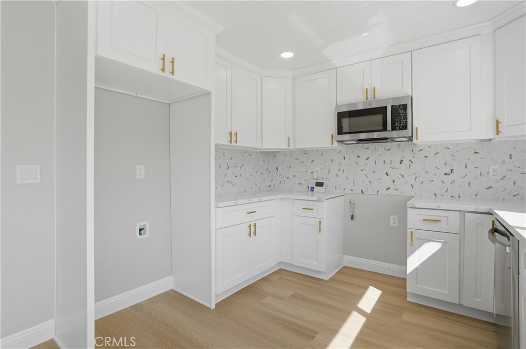 2924 Louisiana Place Riverside, CA 92506 - Photo 24 of 42 a kitchen with stainless steel appliances white cabinets and a stove top oven