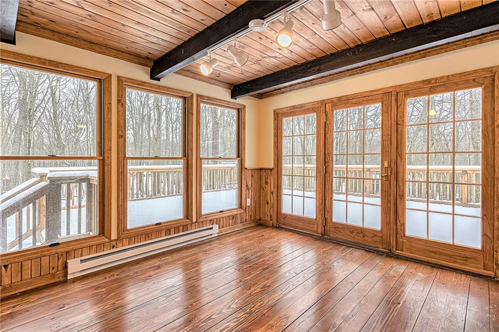 248 Greenbrier Road Acme, PA 15610 - Photo 7 of 35 a view of an empty room with wooden floor and a window