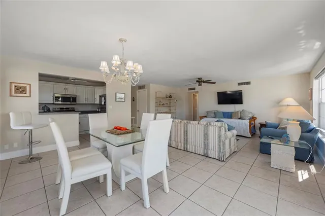 a dining room with furniture and chandelier