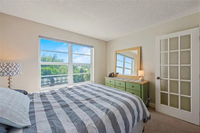 a bedroom with a large bed and a window