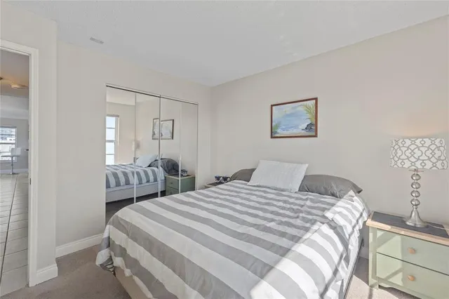 a bedroom with a bed and a lamp