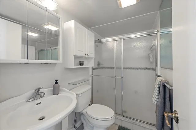 a bathroom with a sink toilet and shower