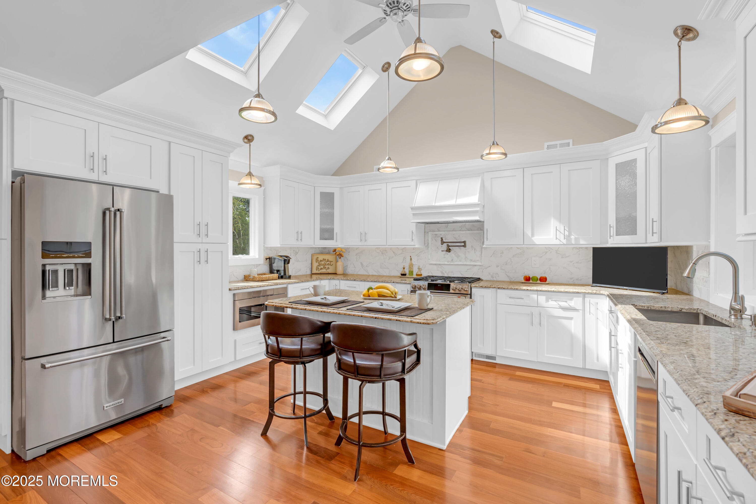 102 Greenwood Road Morganville, NJ 07751 - Photo 3 of 11 a kitchen with granite countertop a stove a sink dishwasher a refrigerator with wooden floor and cabinets