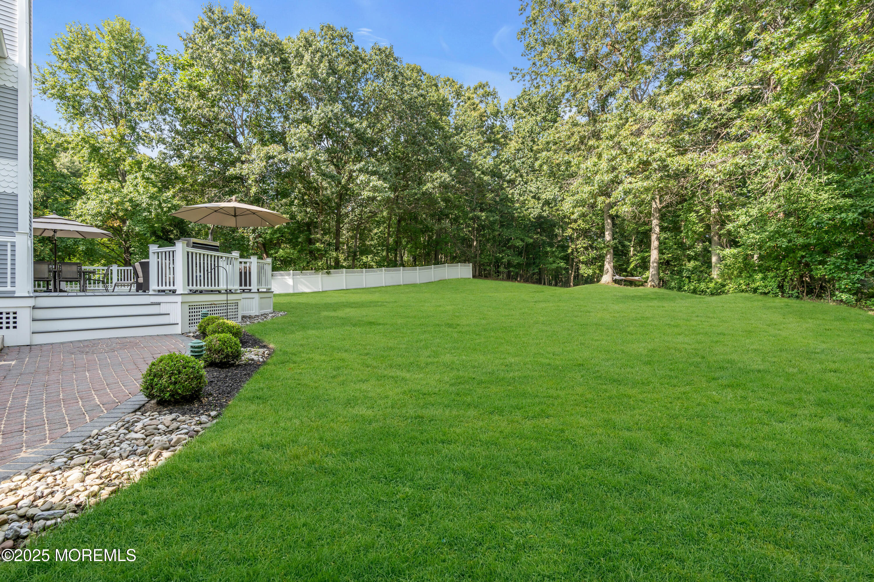 102 Greenwood Road Morganville, NJ 07751 - Photo 9 of 11 a backyard of a house with lots of green space