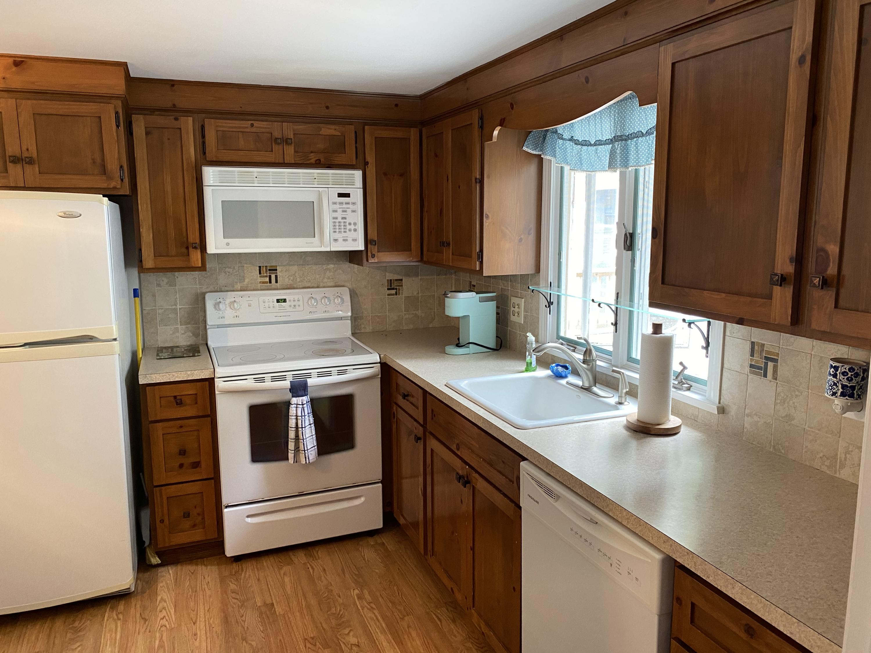 128 Cedric Road Centerville, MA 02632 - Photo 8 of 19 a kitchen with a stove sink and a refrigerator