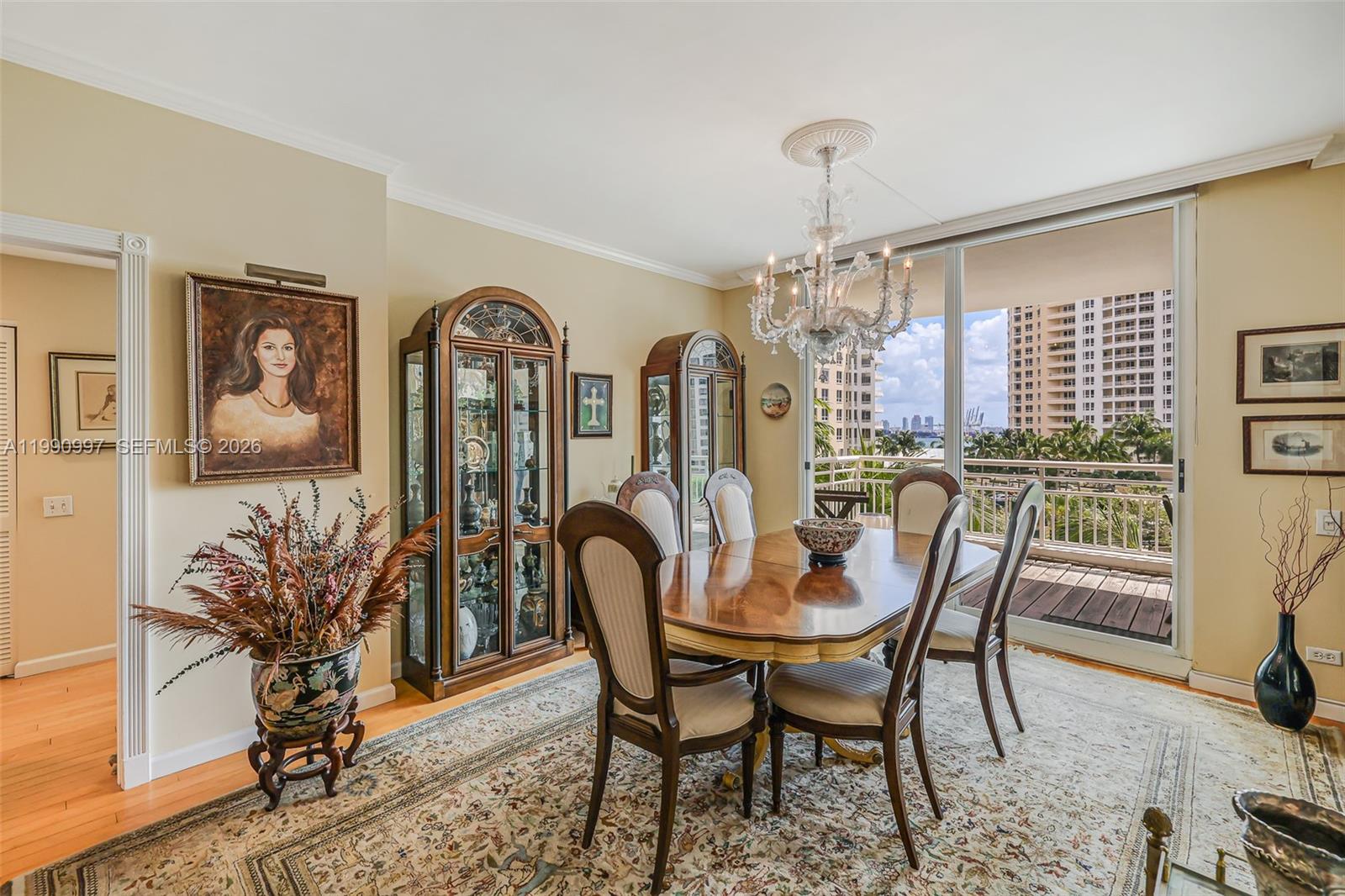 888 Brickell Key Drive, Unit 807 Miami, FL 33131 - Photo 14 of 62 a view of a dining room with furniture and a chandelier