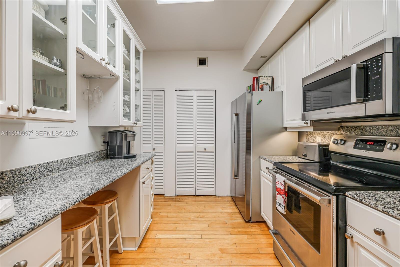 888 Brickell Key Drive, Unit 807 Miami, FL 33131 - Photo 19 of 62 a kitchen with stainless steel appliances granite countertop a sink stove and refrigerator