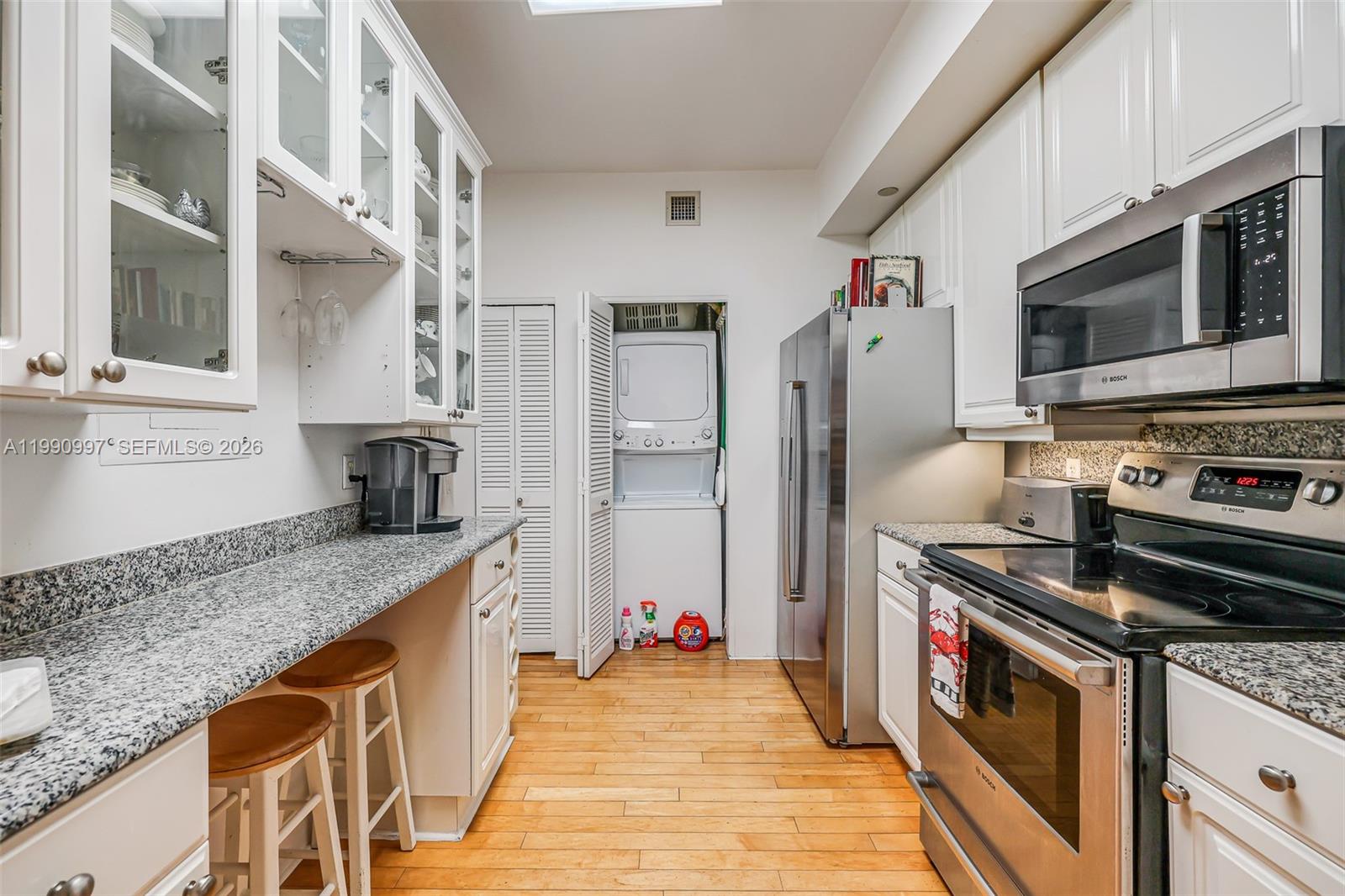 888 Brickell Key Drive, Unit 807 Miami, FL 33131 - Photo 20 of 62 a kitchen with stainless steel appliances granite countertop a sink stove and refrigerator