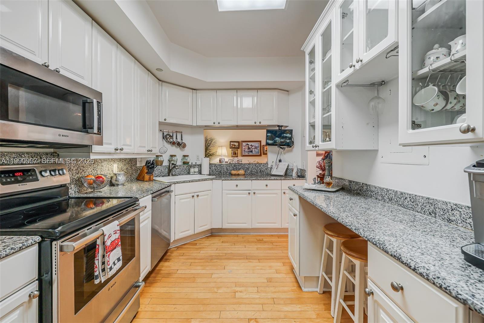888 Brickell Key Drive, Unit 807 Miami, FL 33131 - Photo 21 of 62 a kitchen with stainless steel appliances granite countertop a stove a sink and a microwave