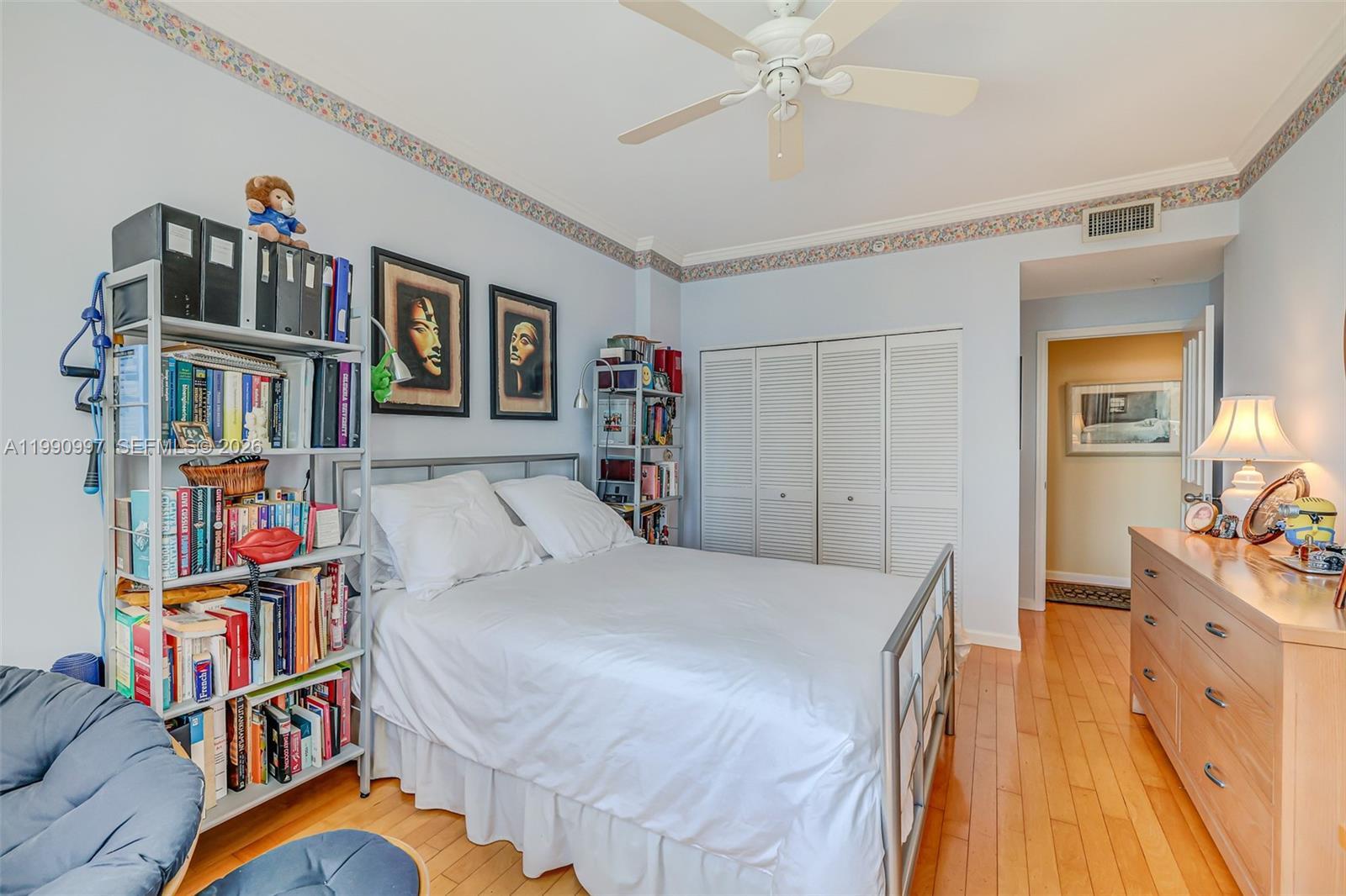 888 Brickell Key Drive, Unit 807 Miami, FL 33131 - Photo 28 of 62 a bed room with a bed and a book shelf
