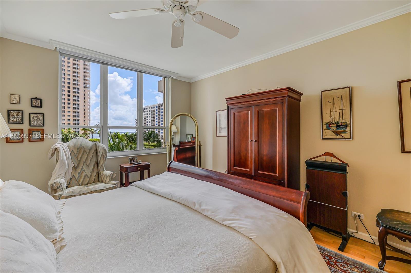 888 Brickell Key Drive, Unit 807 Miami, FL 33131 - Photo 31 of 62 a bedroom with a bed and wooden furniture