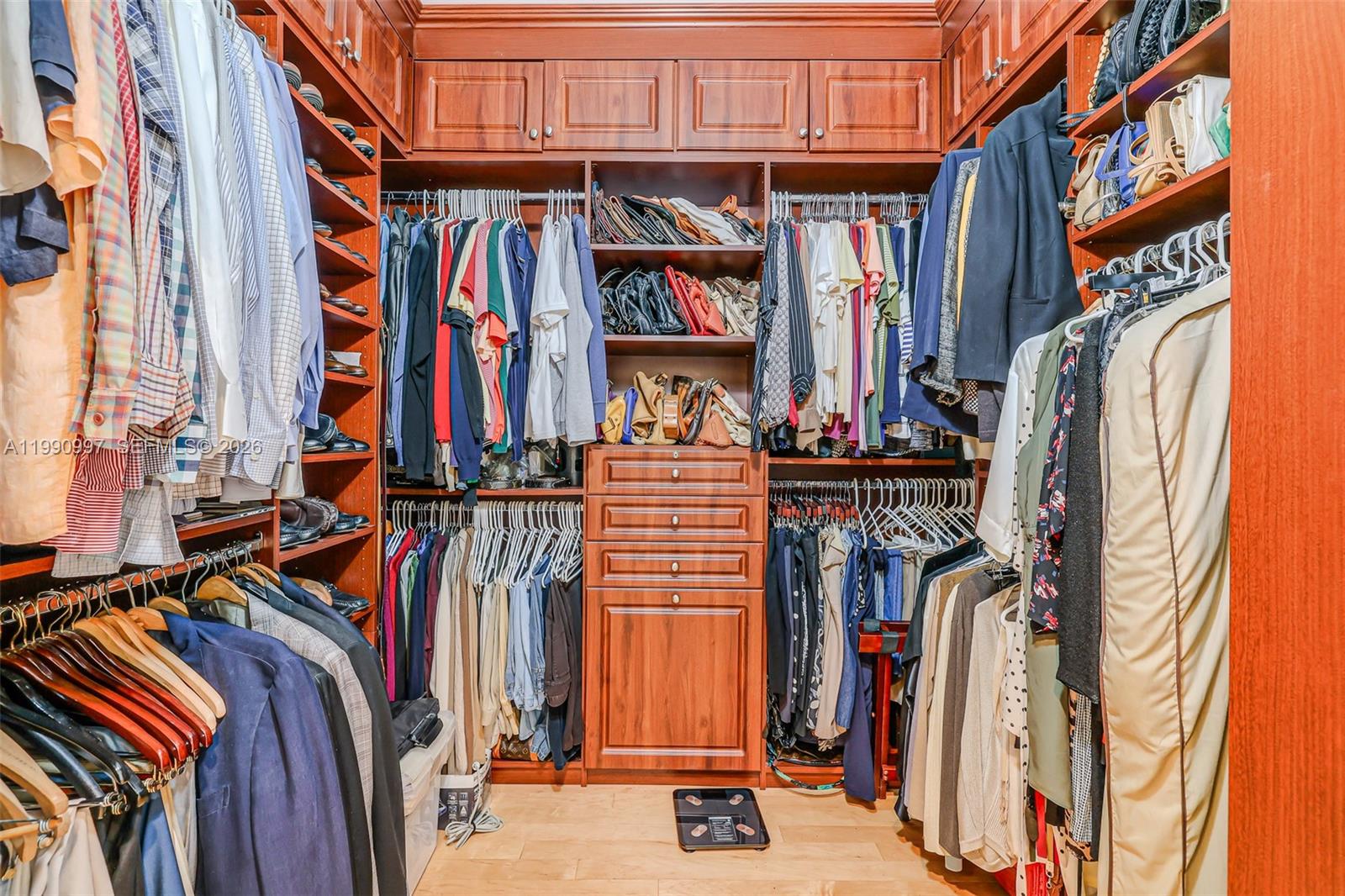 888 Brickell Key Drive, Unit 807 Miami, FL 33131 - Photo 35 of 62 a view of walk in closet with clothes and shoes