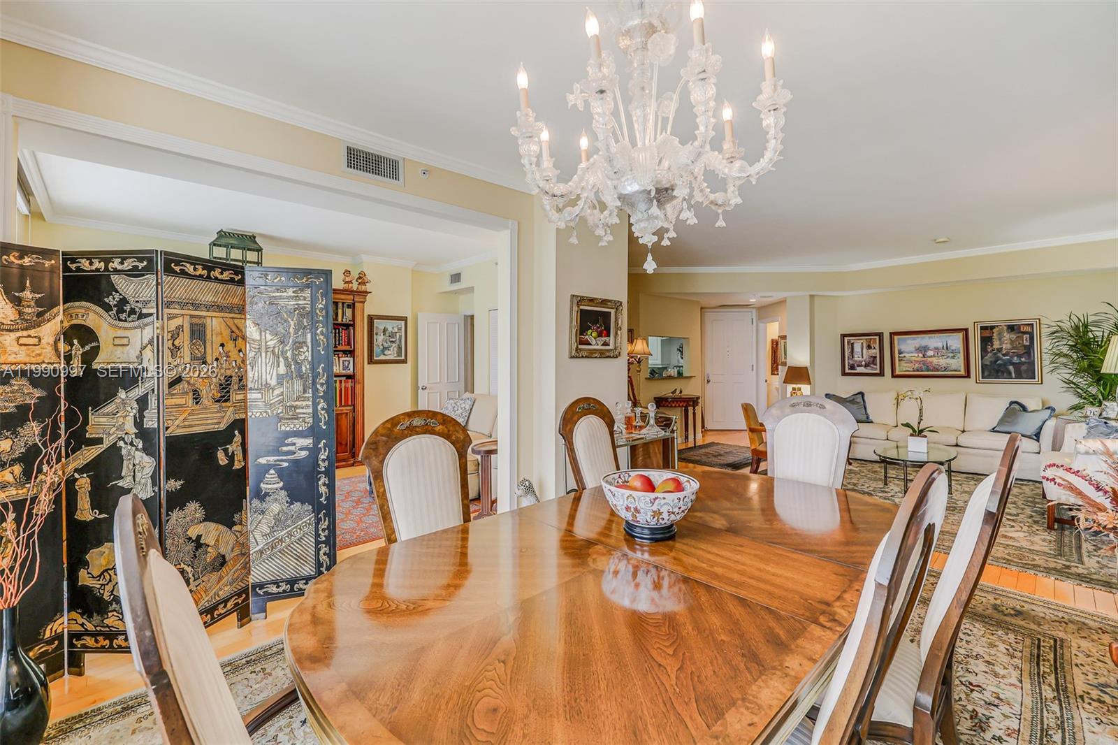 888 Brickell Key Drive, Unit 807 Miami, FL 33131 - Photo 39 of 62 a dining room with furniture a chandelier and wooden floor