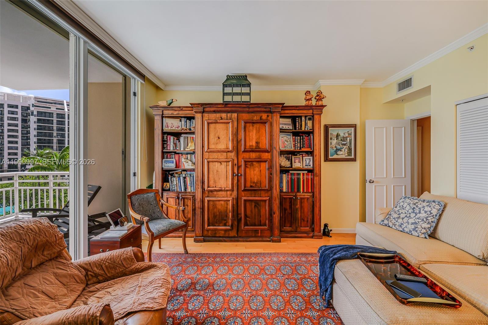 888 Brickell Key Drive, Unit 807 Miami, FL 33131 - Photo 40 of 62 a bedroom with furniture and a book shelf