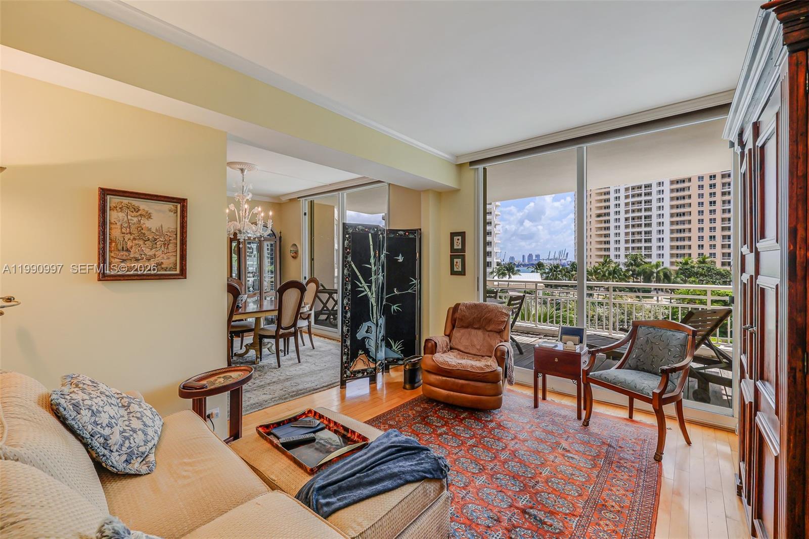 888 Brickell Key Drive, Unit 807 Miami, FL 33131 - Photo 41 of 62 a living room with furniture and a floor to ceiling window