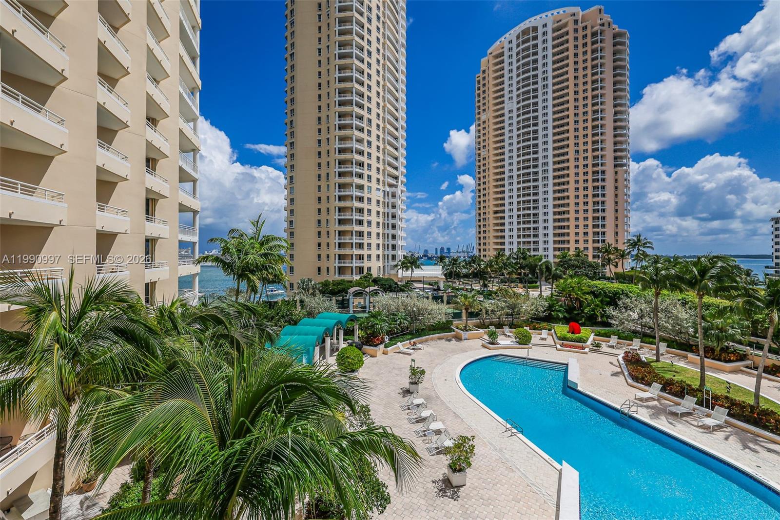 888 Brickell Key Drive, Unit 807 Miami, FL 33131 - Photo 48 of 62 a swimming pool with outdoor seating and yard