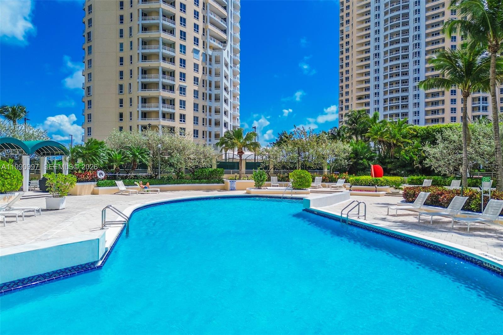 888 Brickell Key Drive, Unit 807 Miami, FL 33131 - Photo 60 of 62 a view of swimming pool with outdoor seating and plants