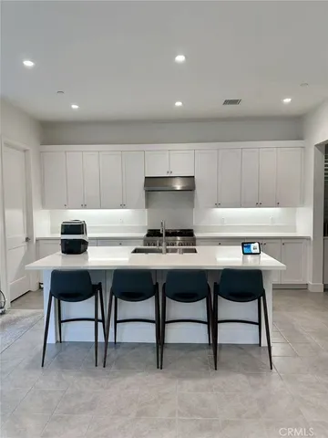 a kitchen with a dining table chairs and window