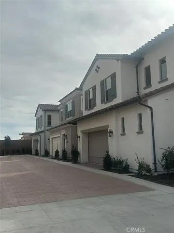 a front view of a house with a road