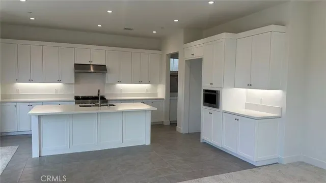 a kitchen with stainless steel appliances a stove refrigerator sink and cabinets