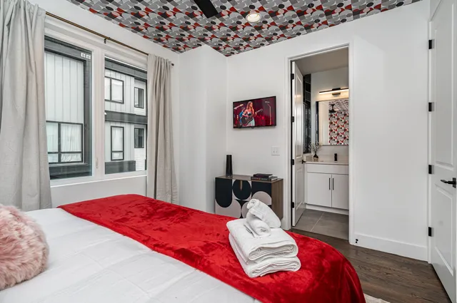 a bedroom with a bed and a chandelier