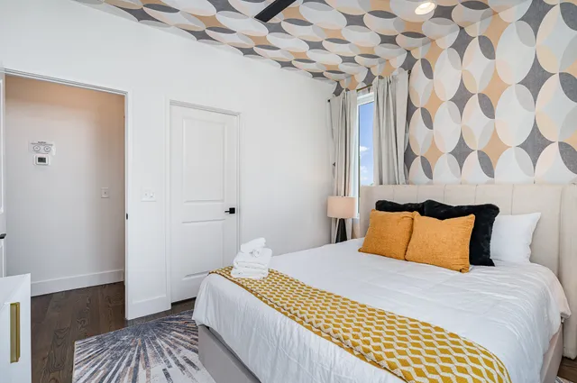 a bedroom with a bed and a dresser