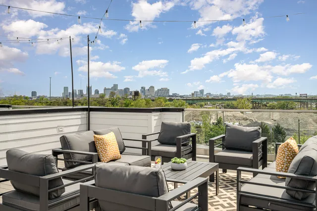 a terrace with outdoor seating and city view