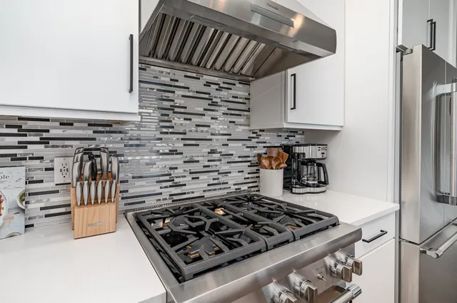 a kitchen with a stove and a refrigerator
