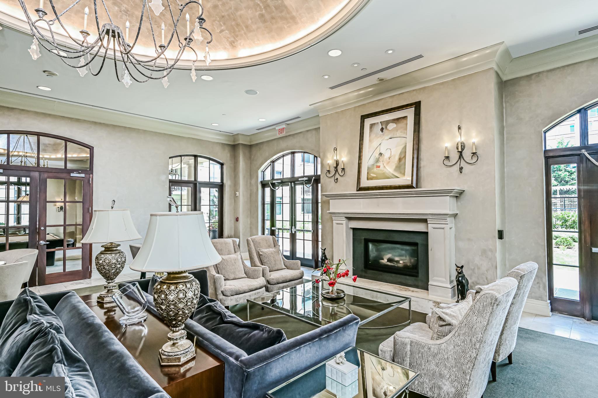 11710 Old Georgetown Road, Unit 1212 Rockville, MD 20852 - Photo 12 of 55 a living room with furniture a fireplace and a chandelier