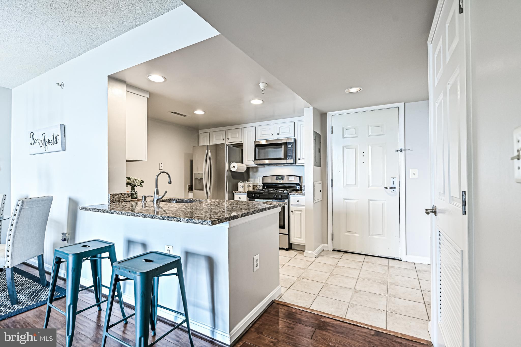 11710 Old Georgetown Road, Unit 1212 Rockville, MD 20852 - Photo 24 of 55 a kitchen with stainless steel appliances granite countertop a sink and cabinets