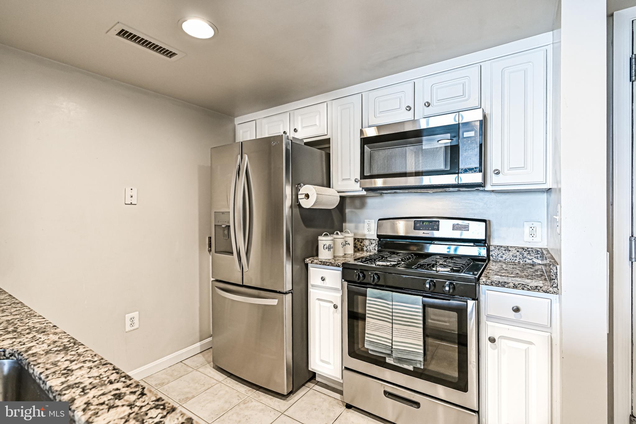 11710 Old Georgetown Road, Unit 1212 Rockville, MD 20852 - Photo 25 of 55 a kitchen with granite countertop a stainless steel appliances and cabinets