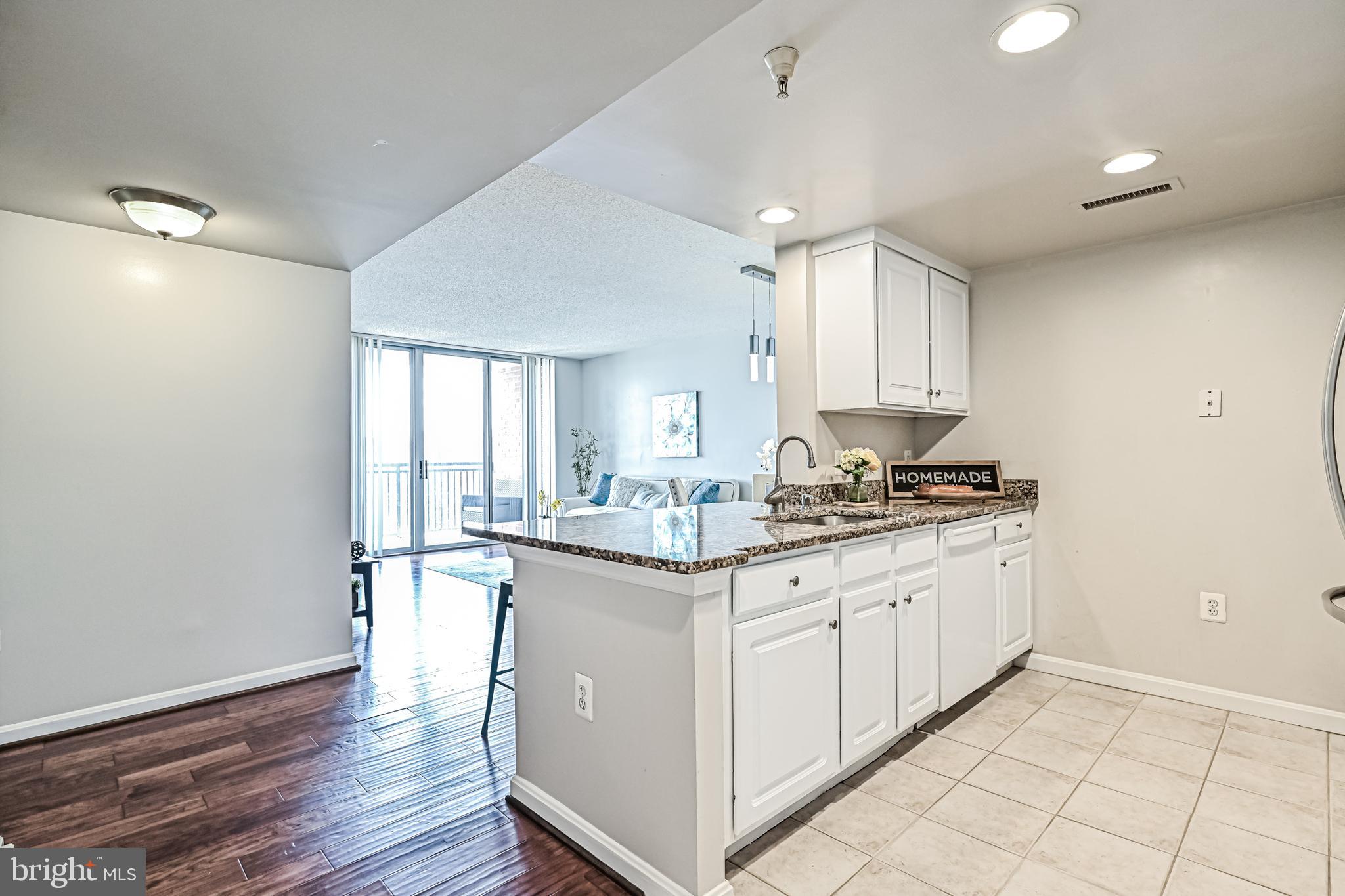 11710 Old Georgetown Road, Unit 1212 Rockville, MD 20852 - Photo 27 of 55 a kitchen with granite countertop a sink and cabinets